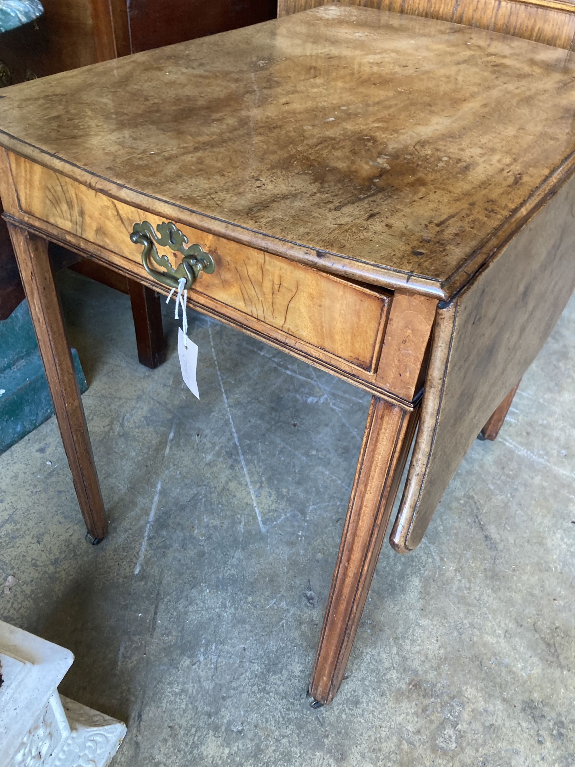 A George III mahogany Pembroke table, with serpentine shaped top, single drawer, on square section supports, width 76cm, depth 52cm, he